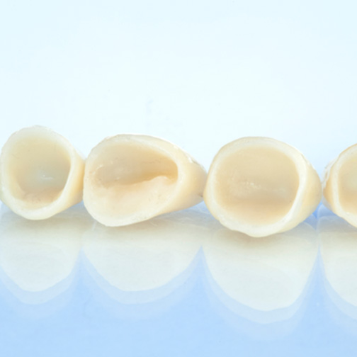 Four dental crowns in Fort Worth, TX, sitting in a row