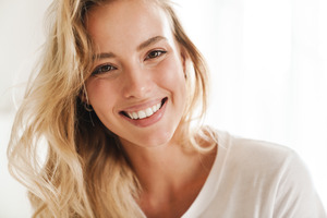 Close-up of smiling woman in a white shirt